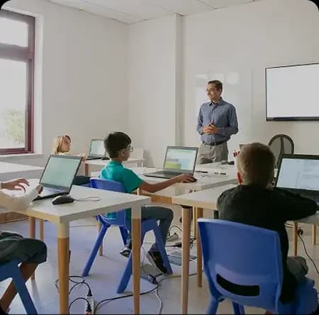 Teacher guiding students in a classroom